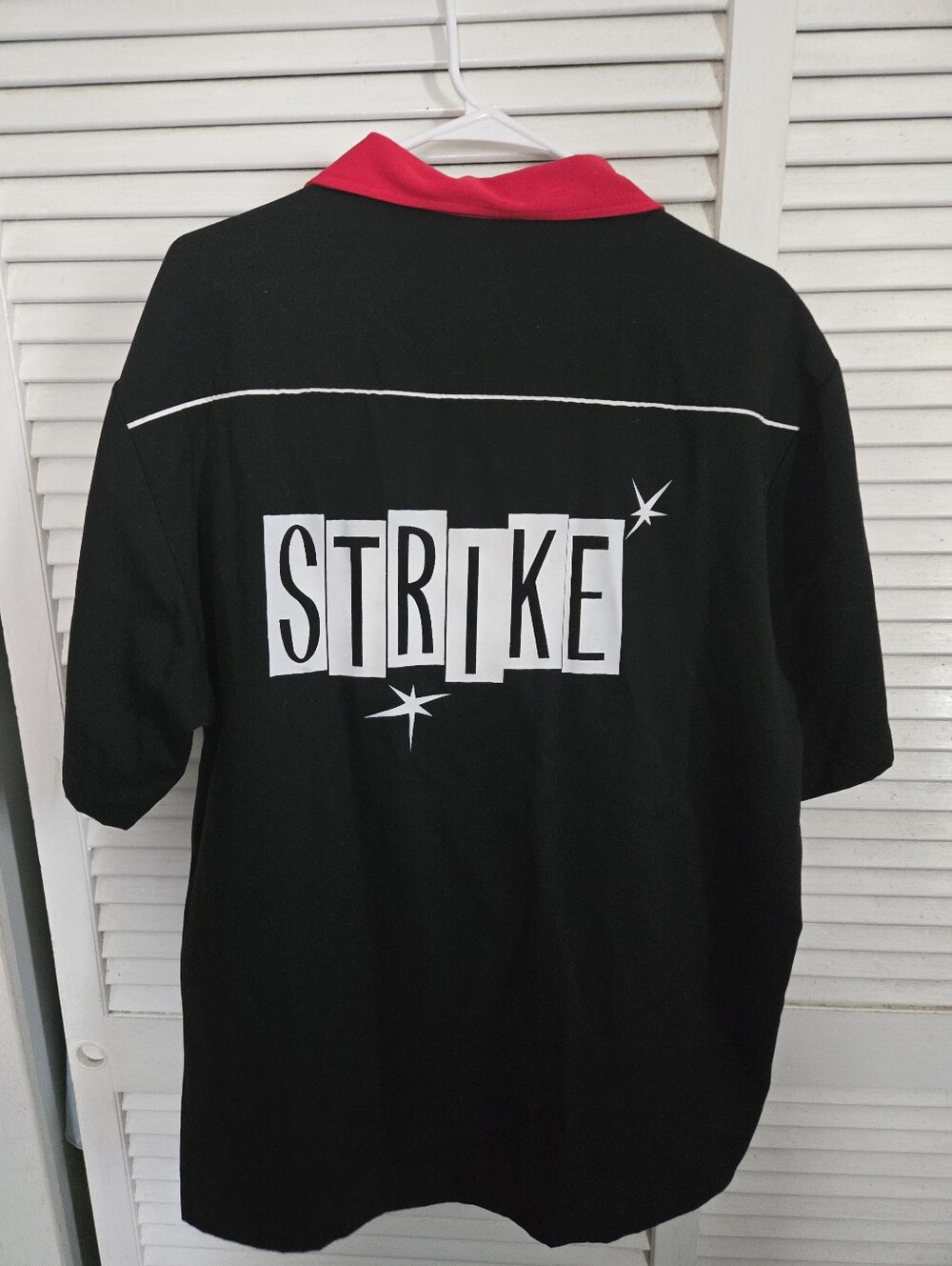 LG Black Short-Sleeve Polo with Red Collar and 'STRIKE' Graphic